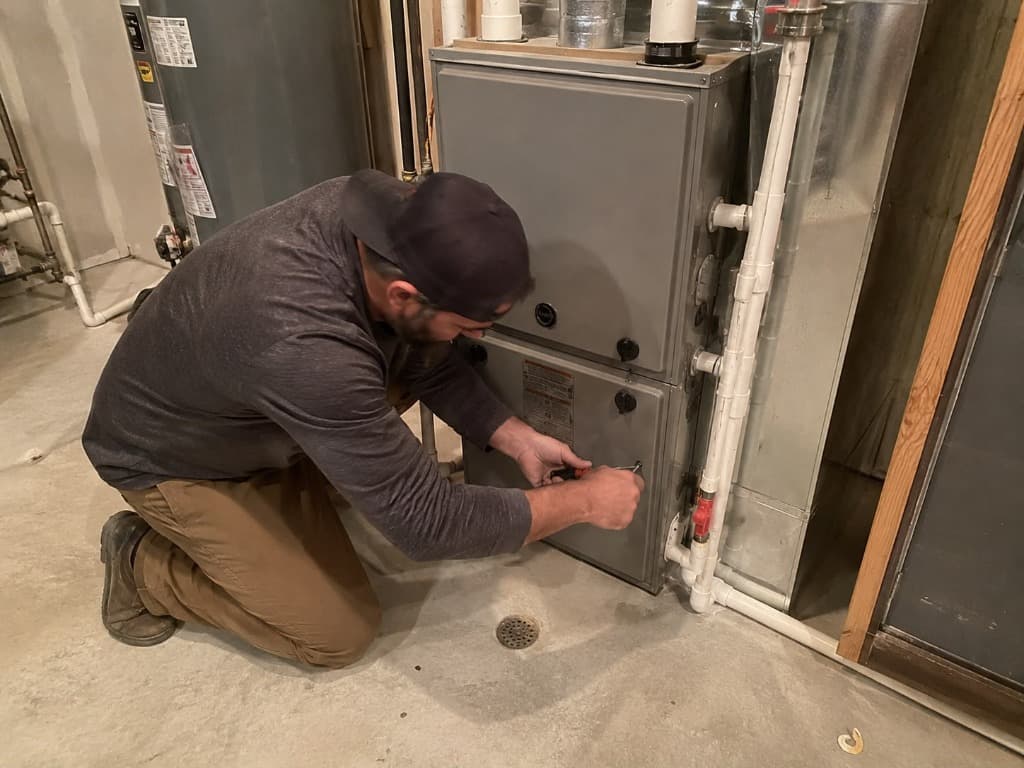 Heating System Services - Professional Texas HVAC Service Airnet HVAC technician performing heating system repair and furnace diagnostic check